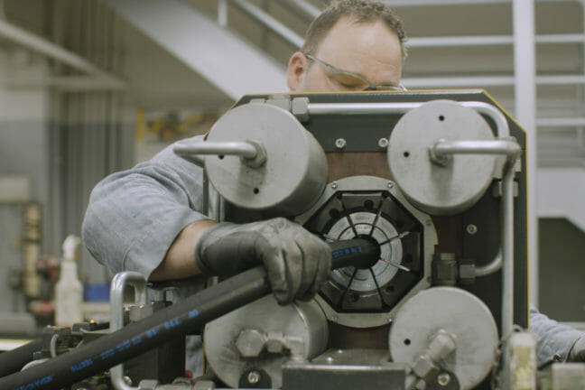 man working on a hydraulic hose repair