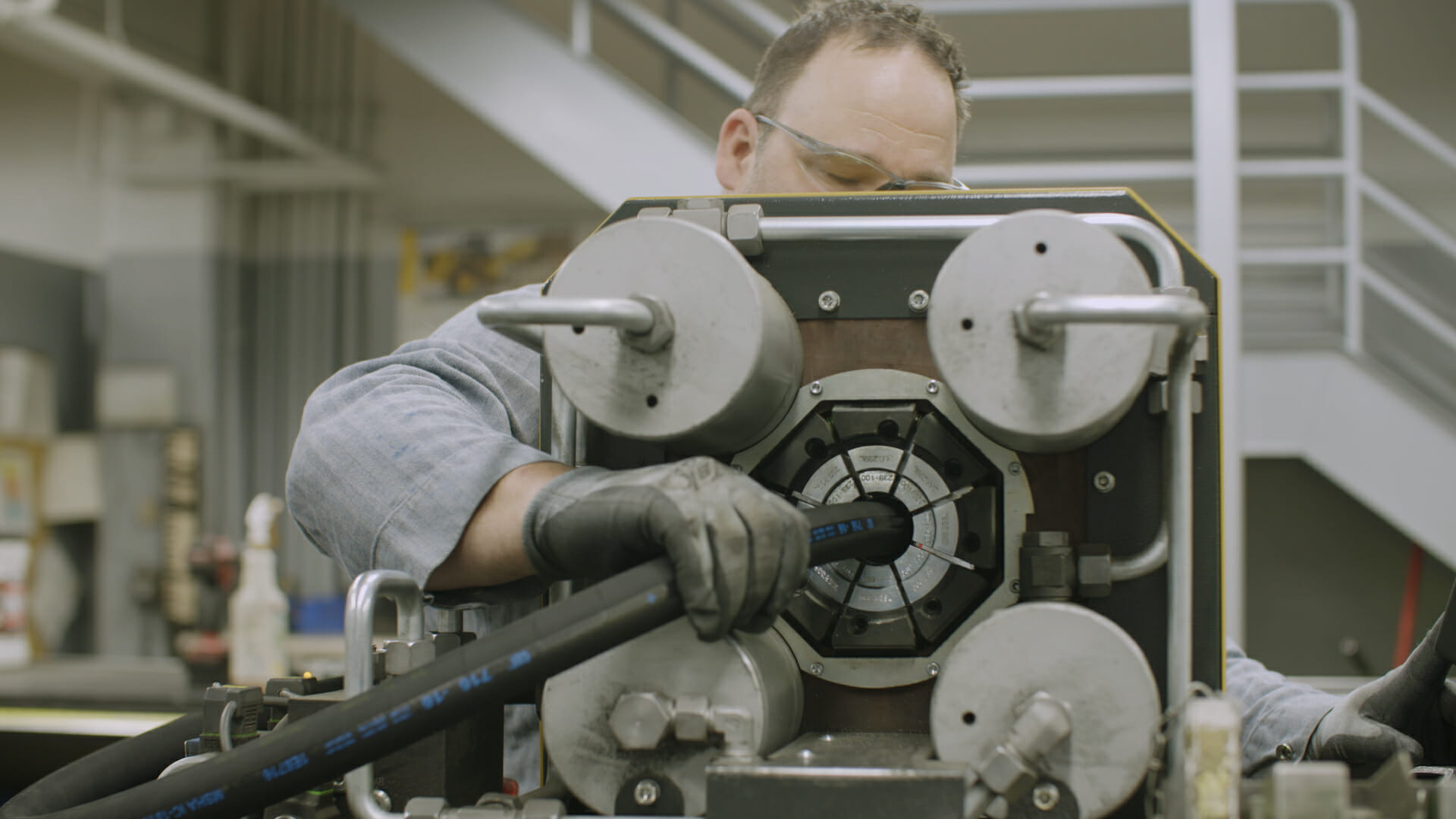 man working on a hydraulic hose repair