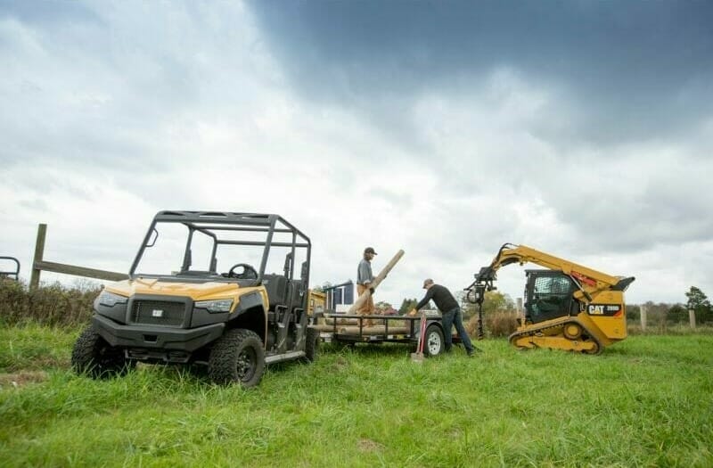 cat utv and excavator in a field