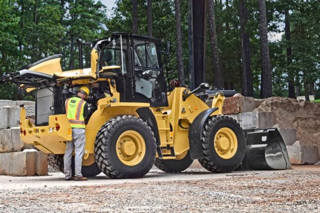 Cat equipment operator working on equipment