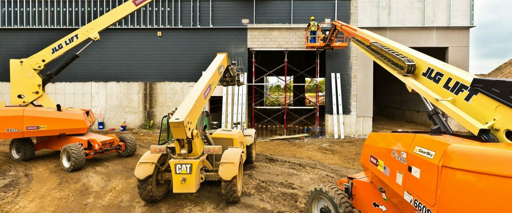 Cat heavy equipment rental machines constructing a building