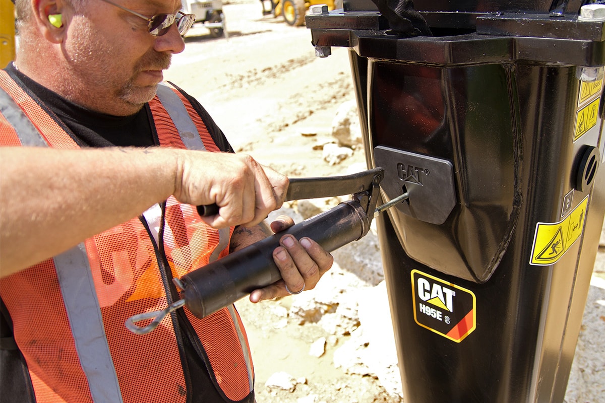 Man greasing a hammer