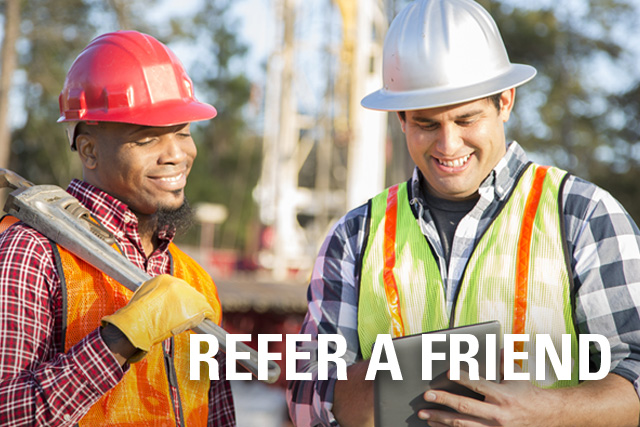 Two construction workers looking at iPad