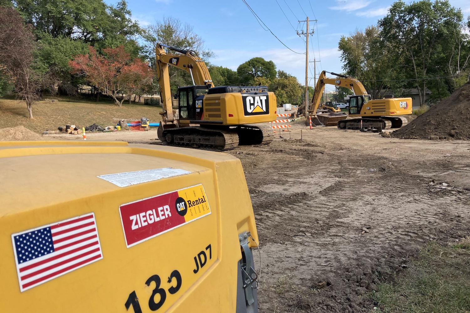 Compressor and Excavators Rented generator located on a job site