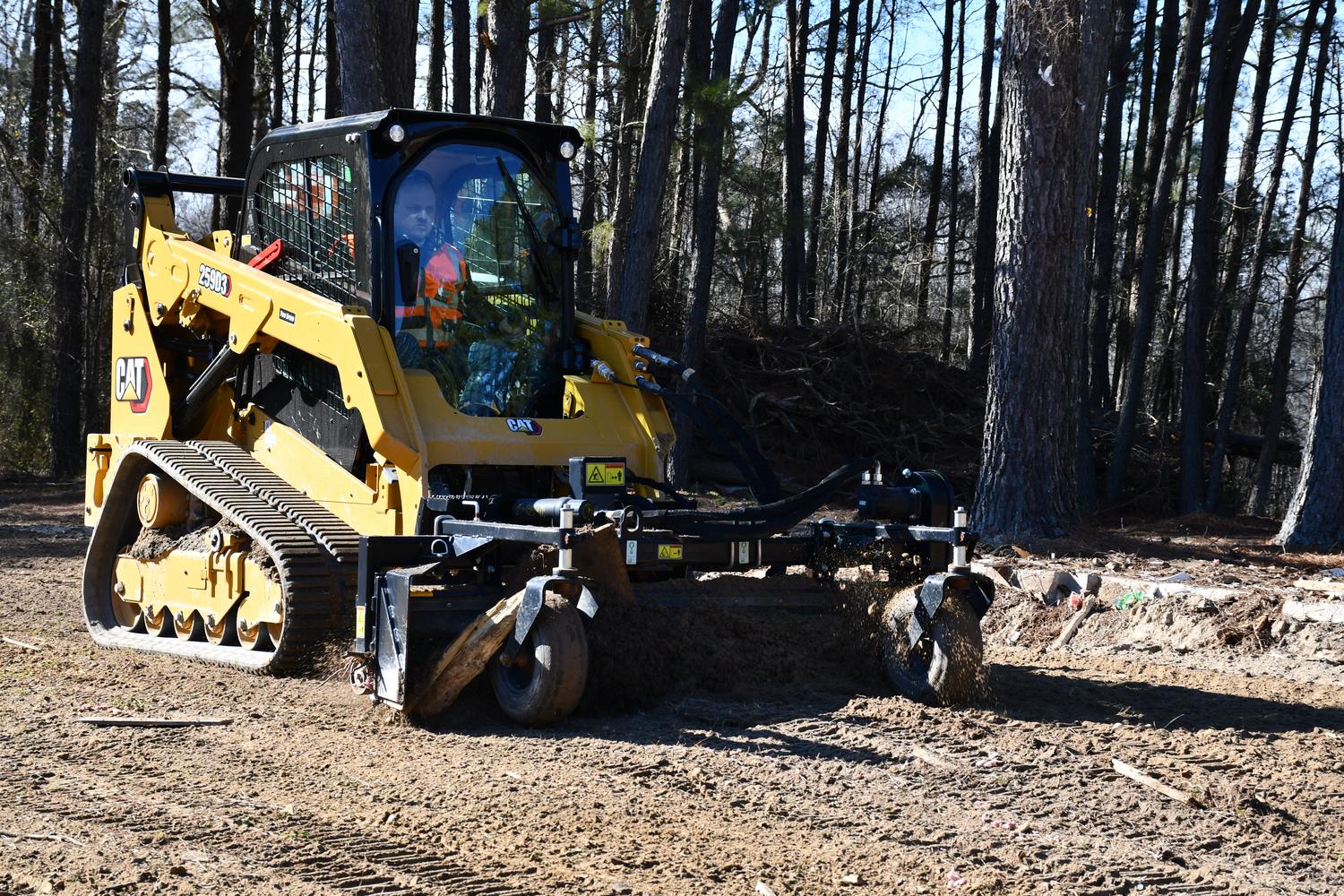 Rent-CAT-skid-steer Rented CAT skid working in woods