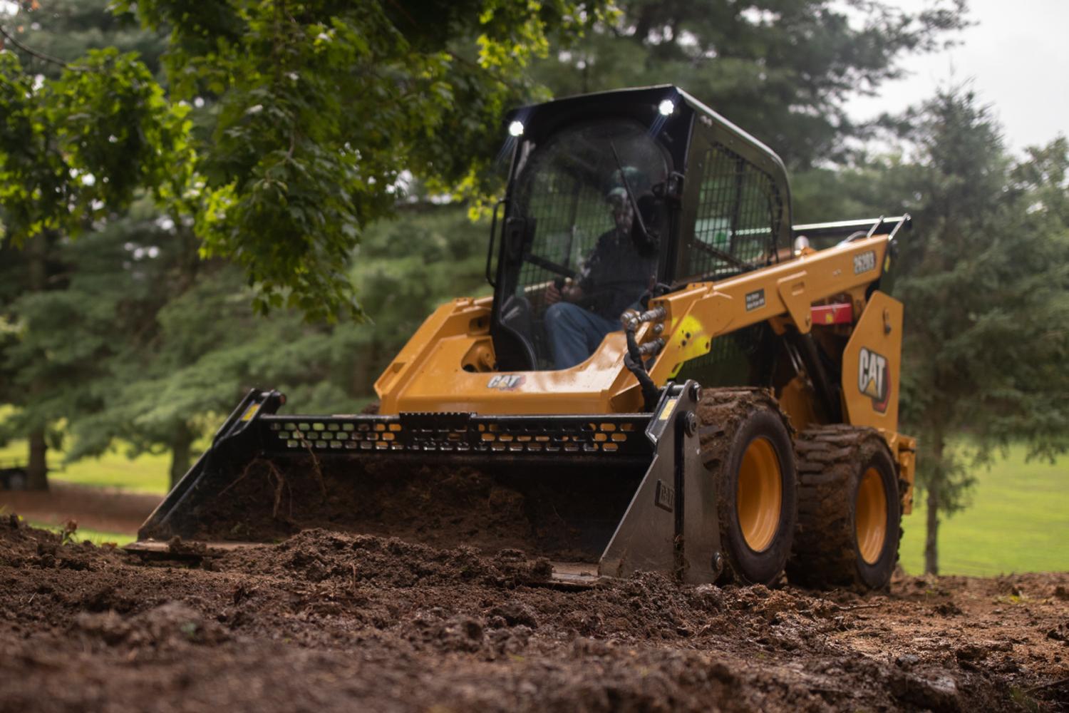 Rental-CAT-skid-steer CAT rentable skid steer moving dirt at a job site