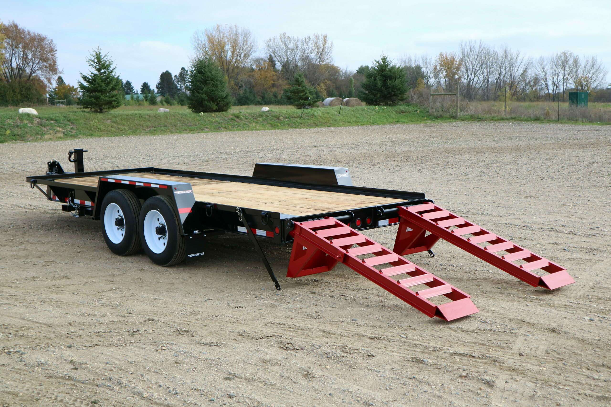 towmaster drop-deck trailer in a dirt field